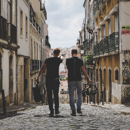 Photo of two men walking down city street