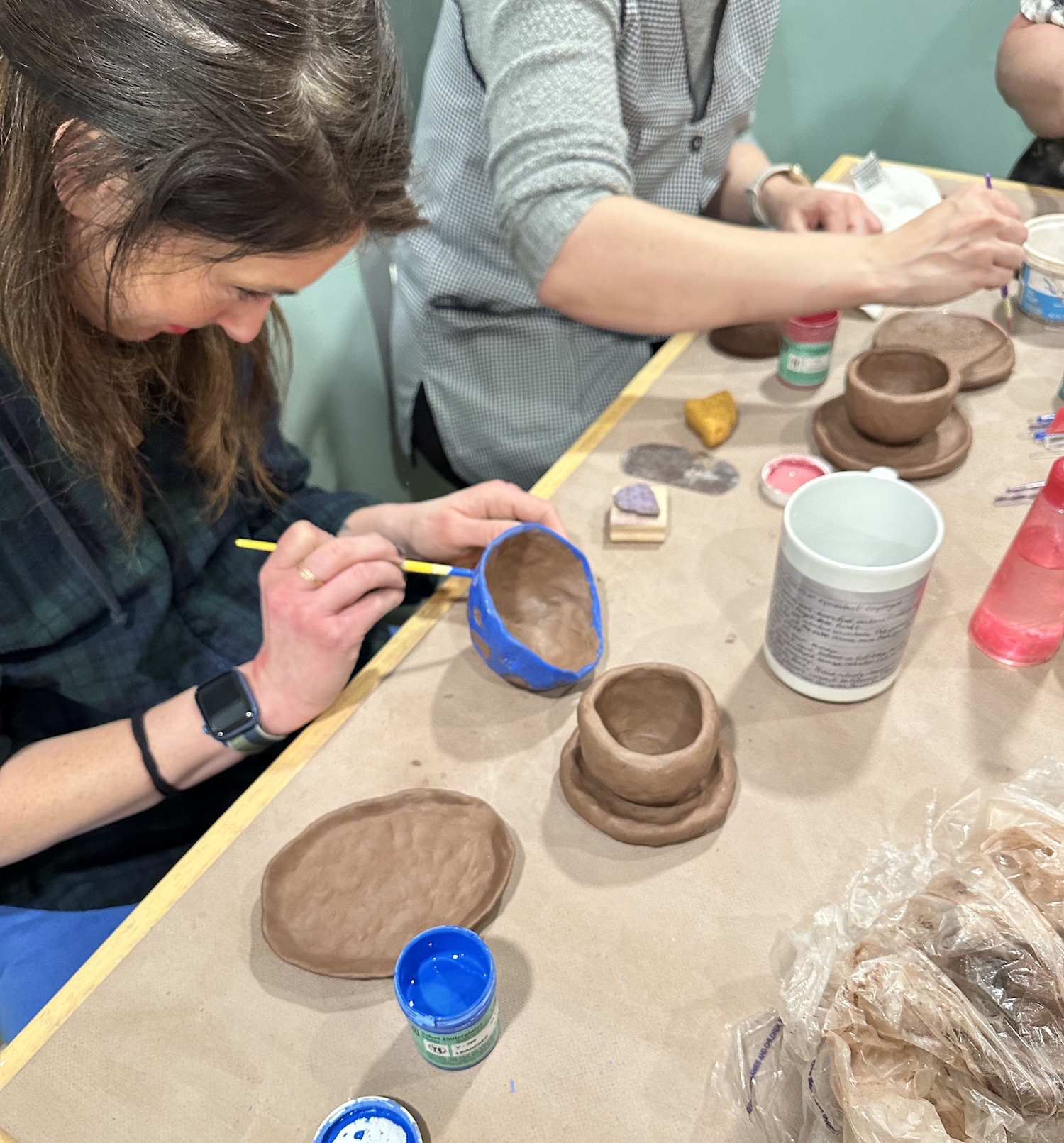 Potters hand-building in a studio.
