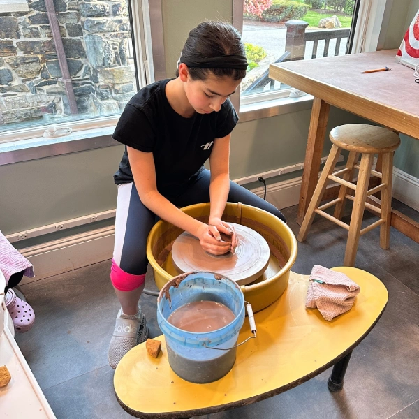 teenager at the pottery wheel at FYACS