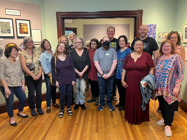 ArtofWords2024 A group of smiling people in a gallery