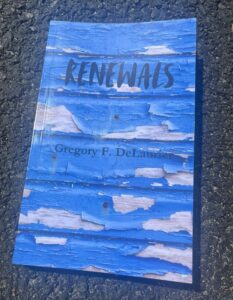 Book cover of Renewals, a novel by Greg F. DeLaurier. Title set in black type over photo of clapboard siding with blue peeling paint.