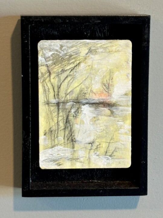 Mixed media artwork by David Winkler evoking a cold winter landscape with barren trees and a frozen river bed or pond. Yellow background suggests sunrise or sunset.
